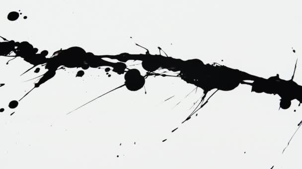 Salpicaduras de tinta artística abstracta, gotitas de pintura negra cayendo y extendiéndose sobre fondo blanco de cerca. Derramando pintura. Manchas de pintura sobre una superficie blanca. Movimiento lento. — Vídeo de stock