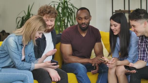 Diverse group of young creative startups, discuss startup of new mobile application. Multiethnic team discusses ideas and strategies of startup new project through brainstorming. Slow motion. — Stock Video