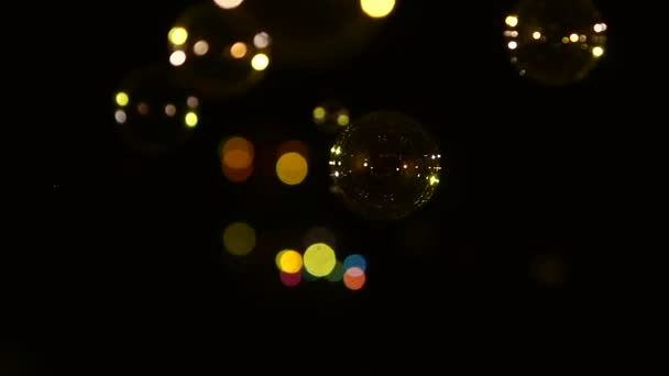 Blue, red, brown and orange soap bubbles on black, background, close up, slow motion — Stock Video