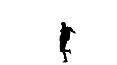 Young b-boy man doing brake dancing movements, on white, slow motion, silhouette