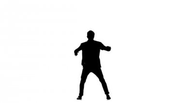 Young b-boy man in shirt doing brake dancing movements, on white, slow motion, silhouette