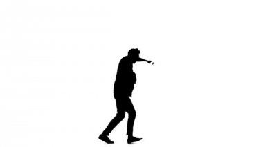 Young, stylish man continue doing brake dancing movements, on white, slow motion, silhouette