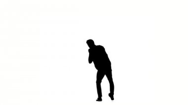 Young hip-hop man doing brake dancing movements, on white, slow motion, silhouette