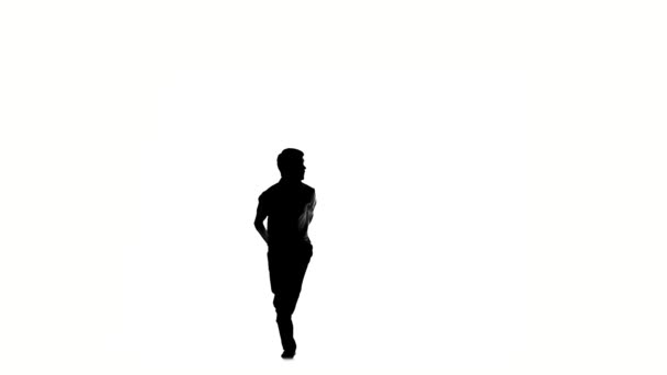 Young, man doing brake dancing movements, on white, slow motion, silhouette — Stock video