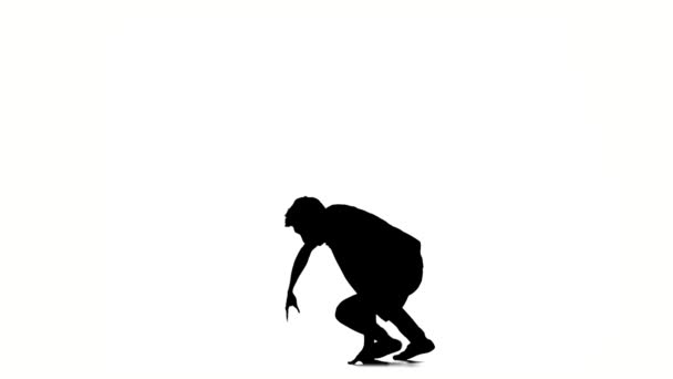 B-boy style dancer performing, on a white background, slow motion, silhouette — Stock Video