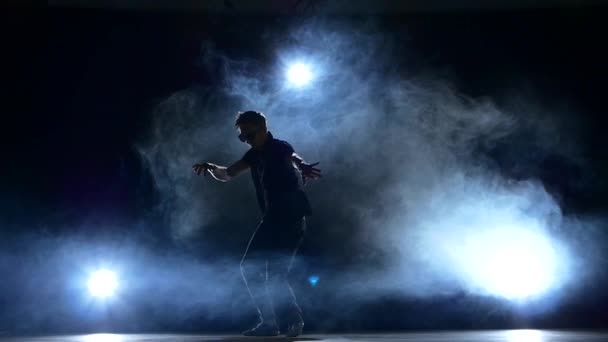 Young hiphop dancer making a move, smoke, silhouette, slow motion — Stock Video