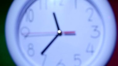 white clock on colorful background