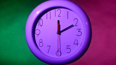 white clock on colorful background, night