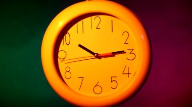 white clock on colorful background