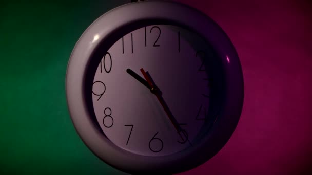 White Clock on color wooden plank wall, night Light — Stockvideo
