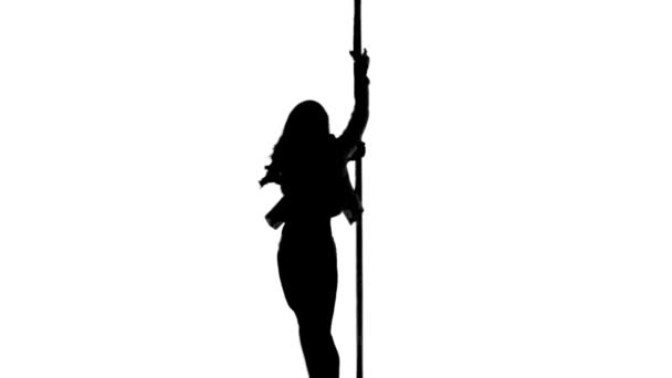 Una donna caucasica pole dancer danza in studio silhouette isolato su sfondo bianco — Video Stock