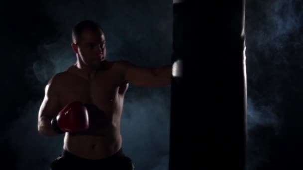 Boxer training shadow boxing over black background. Slow motion. — Stock Video