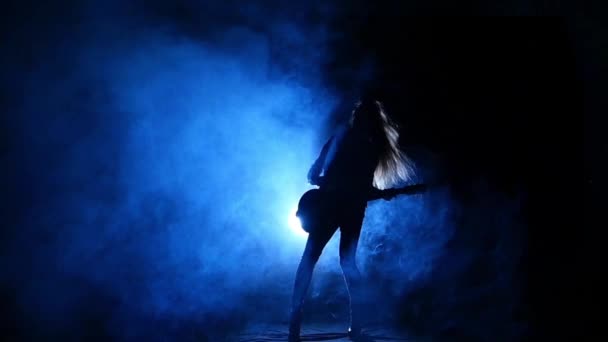 Silhouette of a young girl playing on electric guitar. Slow motion. — Stock Video