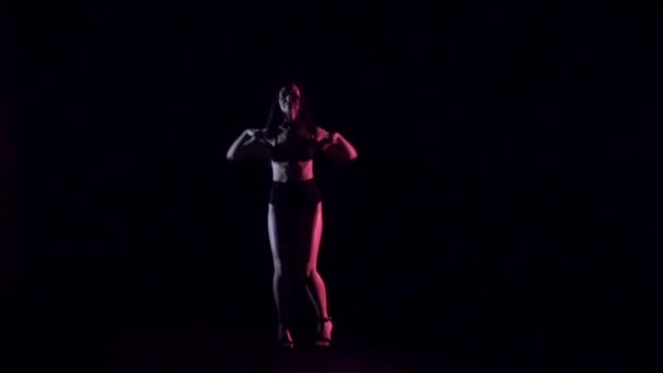 Sexy woman dancing, dark background. Slow motion. — Stock Video