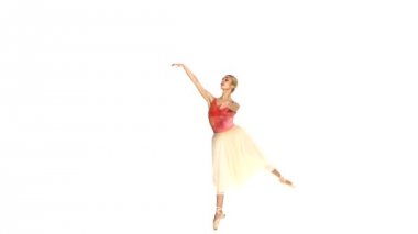 Young ballerina spinning on white background