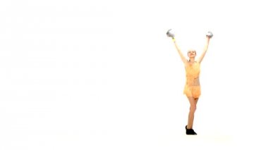 Young cheerleader with pom-poms smiling at camera, acrobatic wheel double