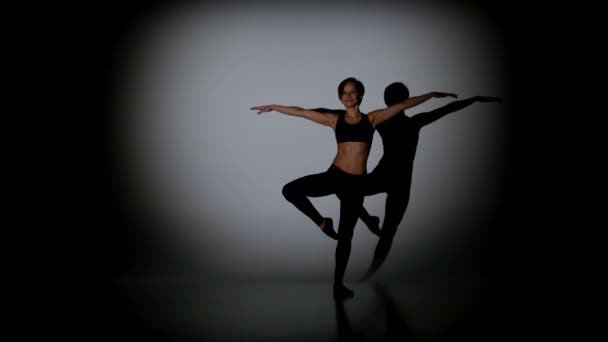 Beautiful girl dancing contemp on a black background, spot light — Stock Video