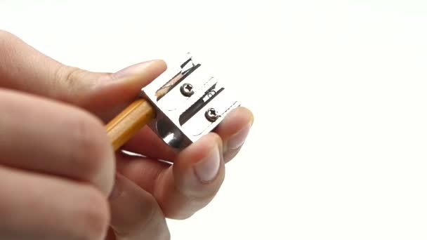 Person sharpen a pencil on white, slow motion — Stock Video