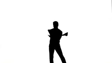 Young bartender does a trick with a shaker. silhouette. slow motion