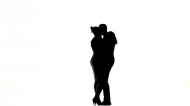 Young girl and afro american man with naked torso finish dancing social latino dancers dancing on white, silhouette