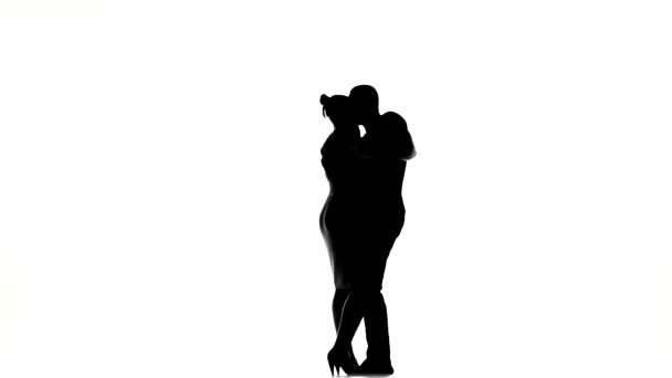 Young girl and afro american man with naked torso finish dancing social latino dancers dancing on white, silhouette — Stok video