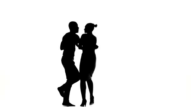 Girl and afro american man with naked torso barefoot dancing social latino dancers dancing on white, silhouette — Stock Video