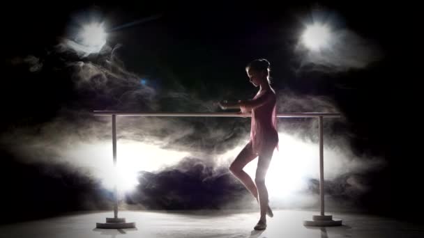 Mooie ballerina danser in de buurt van de barre. Rook — Stockvideo