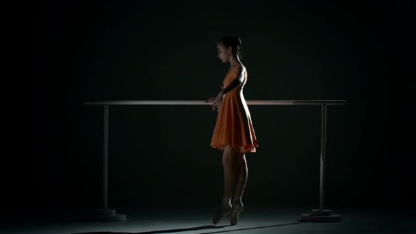 Little ballerina in the ballet hall on black. slow motion — Stock Video