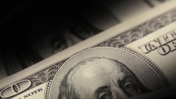One hundred dollars banknotes macro in a darkroom. — Stock Video
