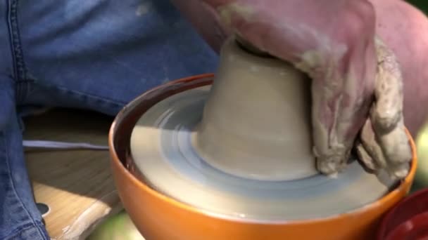 Hands working on pottery wheel , close up retro style toned photo wit shallow DOF — Stock Video