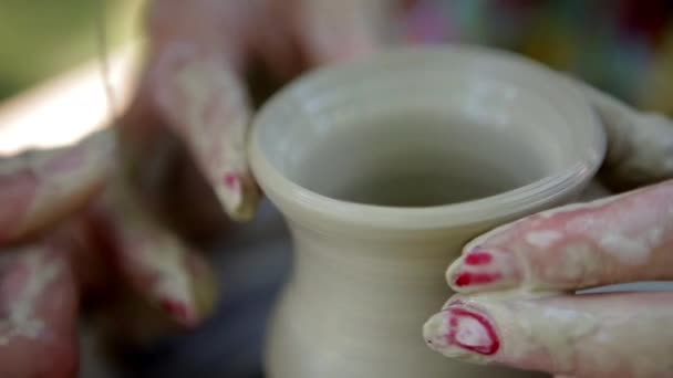 Hands working on pottery wheel , close up retro style toned photo wit shallow DOF — Stock Video