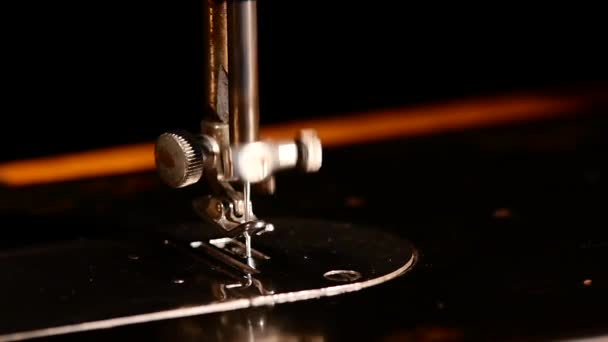 Working sewing machine isolated on black background, slow motion — ストック動画