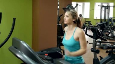 Koşu parkuru spor salonunda bir egzersiz yapıyor atletik kız