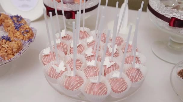 Plate with pink cakes. Close up. Dolly shot. — Stock Video