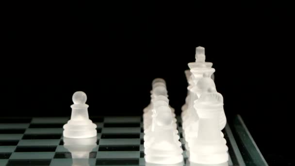 4K. Pawn move on the chessboard. black background. — Stock Video