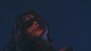 Etkileyici bir kadın portresi dramatik düşük ışıkta, gizemli ve cezbedici bir atmosfer yaratıyor..