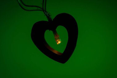 Sıcak, pırıl pırıl bir LED ışığı ahşap bir kalp şeklinde parlar, samimi ve romantik bir atmosfer yaratır..