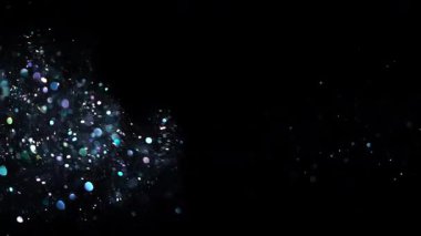 Defocused blurred bokeh background with blue sparkles against a black backdrop. Concept for overlay, events and festive industries, beauty and cosmetics, digital design, advertising and wallpaper.