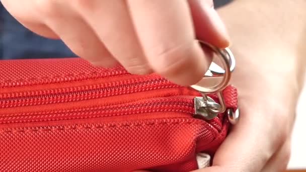 Hand unbutton red handbag, on white, slow motion — Stock Video