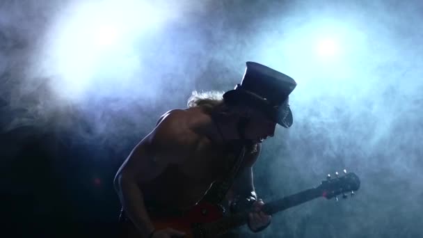 Muscles emotional strip man playing bass guitar, smoke, slow motion — Stock Video