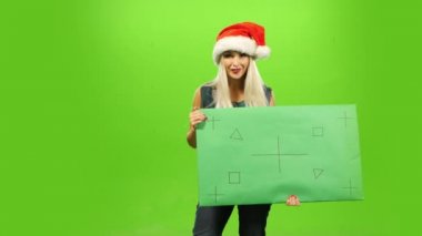 Santa şapka, yeni yıl, yeşil ekran, güzel sarışın kadını boş işareti