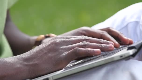 Man Working in Park. a young black guy is sitting. slow motion, close up — Stock Video