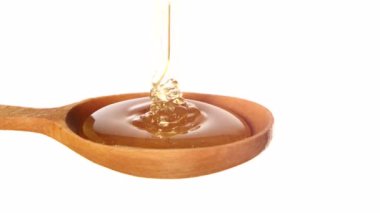 Beyaz ahşap bal ayı üzerinden damlayan bal