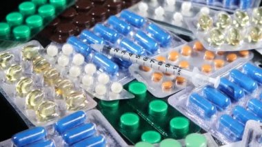 Bazı farklı kontraseptif hapları ve şırınga, rotasyon, yansıma, üst görünüm