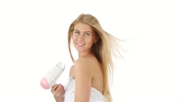Woman in bathroom drying hair with blow dryer, slow motion, bathroom — ストック動画