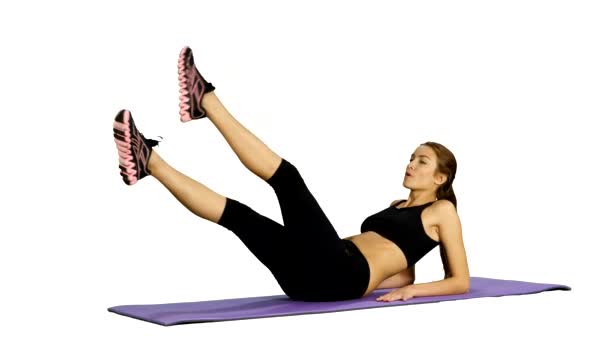 Woman doing strength exercises for abdominal muscles, Gym. white background — 图库视频影像