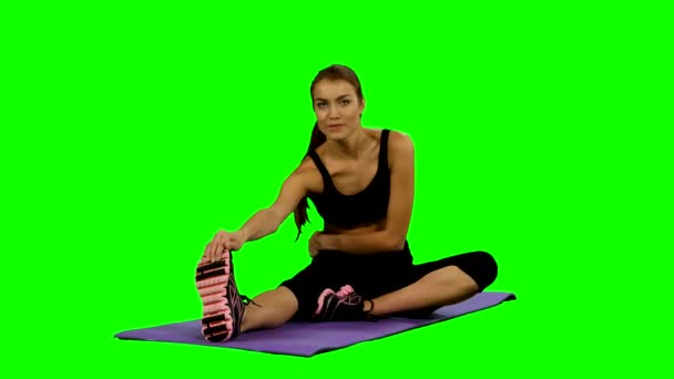 Kvinna som utövar yoga i gym, stretching, grön skärm — Stockvideo