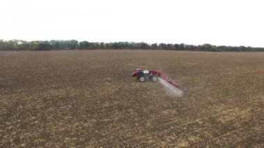 kırmızı traktör tarla mısır sürme. havadan çekim