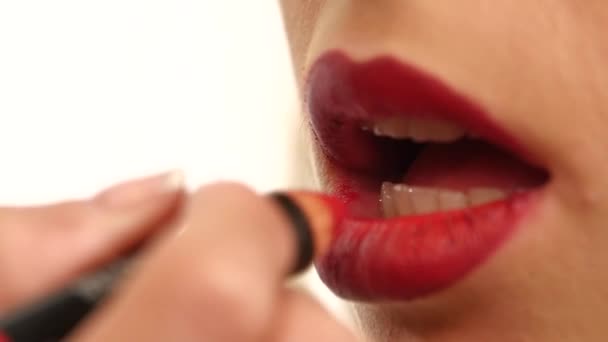 Part of attractive womans face with fashion red lips makeup. Slow motion — Stock Video