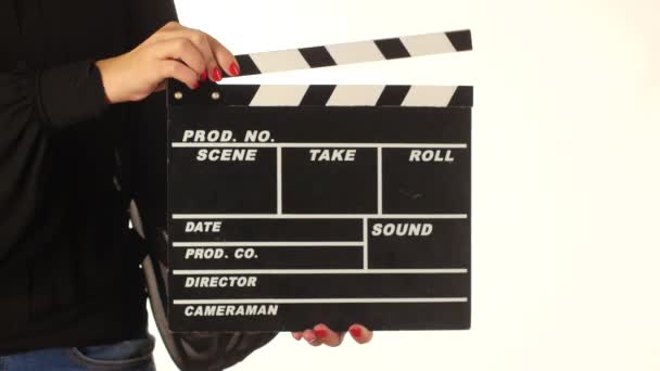 Woman uses movie production clapper board, on white — Stock Video